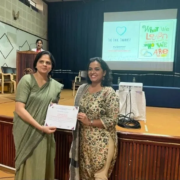 Pashyanthi receiving a certificate after a talk
