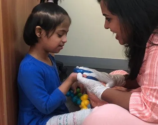 A therapist and a girl playing with building toys together